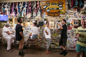 Punters drink in the Daly Waters pub, where every surface is adorned with items left behind by previous visitors