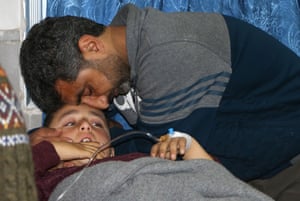 Afrin, Syria A father comforts his son, wounded during a bombardment, after he was taken out of intensive care at a hospital in Afrin.