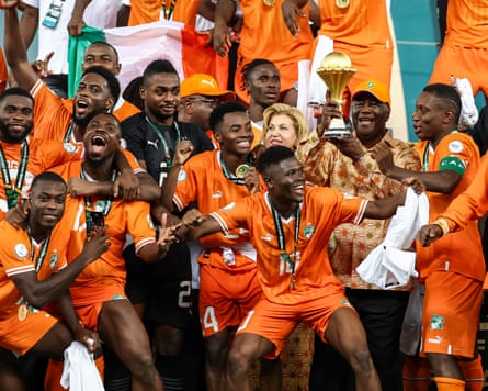 The Côte d’Ivoire president, Alassane Ouattara, lifts the Africa Cup of Nations trophy in 2024.