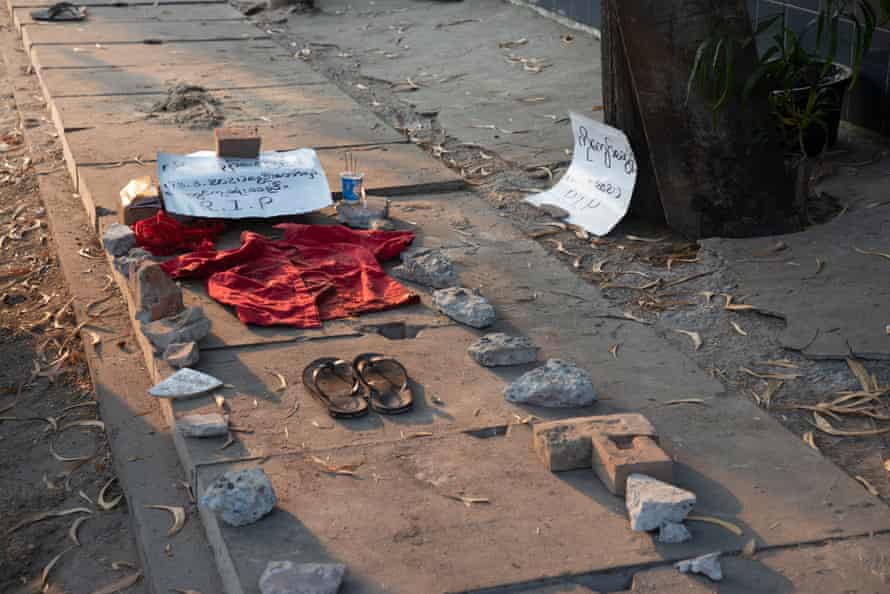 The shirt and sandals of Ye Swe Oo are laid out on a street, with a sign that reads RIP
