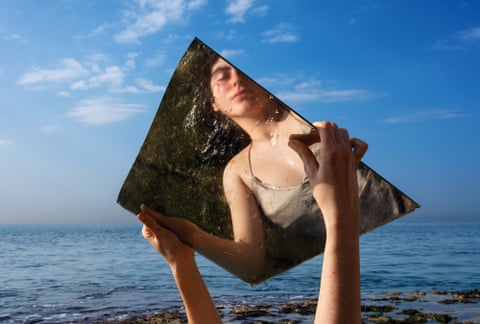 a woman's reflection seen in mirror as she stands by water