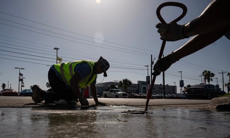 Construction workers do street repair during a heatwave in Corpus Christi, Texas.