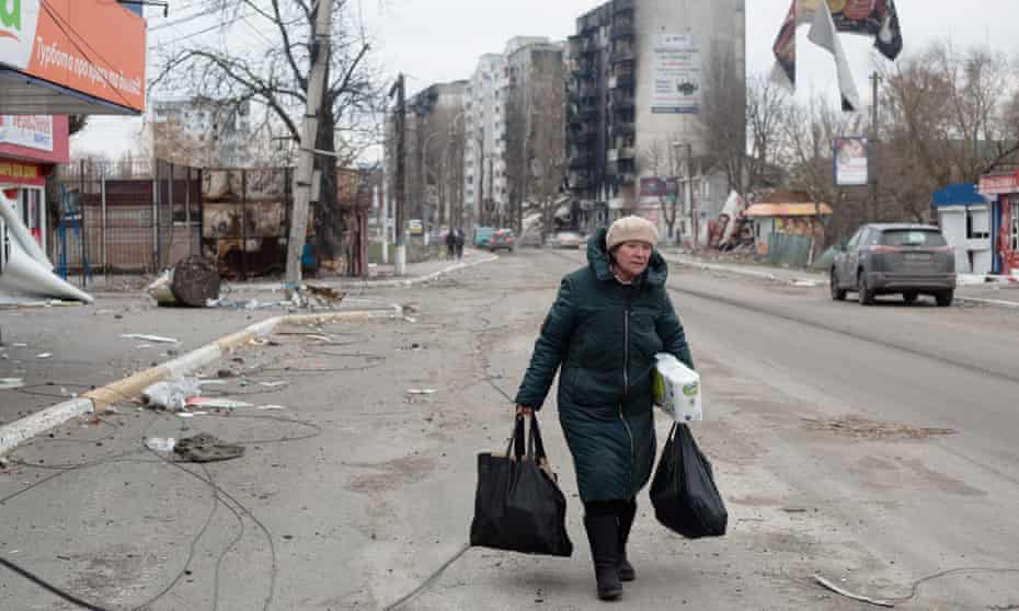 A local resident walks with groceries in Borodianka, Ukraine