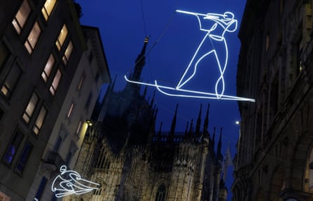 Illuminated figures skiing and shooting in biathlon on a shopping street near the Piazza del Duomo