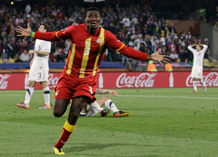 Asamoah Gyan celebrates his goal with outstretched arms