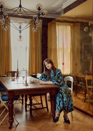 Owner Leith Clark in the dining room, in front of a wall of brass cupboards designed by her partner James Hatt.
