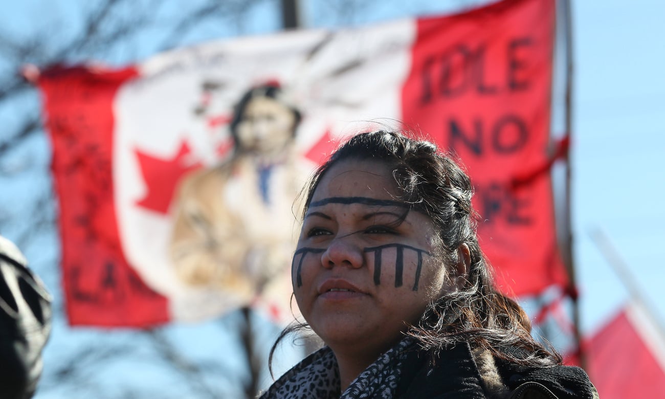 Tayah Doxtator watch traffic as “Idle no more” protesters rally at the base of the Ambassador Bridge between Windsor and the United States. 