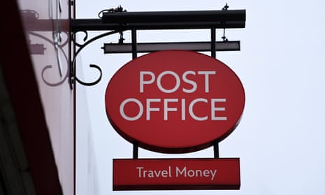 A Post Office sign hanging over a shopfront.
