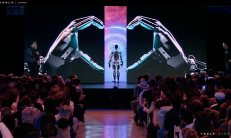 US-AI-ROBOT-TESLA-automobile<br>This video screen grab made from Tesla AI Day 2022 livestream shows Elon Musk (L) presenting the humanoid robot in Palo Alto, California on September 30, 2022. (Photo by Tesla / AFP) / RESTRICTED TO EDITORIAL USE - MANDATORY CREDIT "AFP PHOTO / HANDOUT / TESLA " - NO MARKETING - NO ADVERTISING CAMPAIGNS - DISTRIBUTED AS A SERVICE TO CLIENTS (Photo by -/Tesla/AFP via Getty Images)