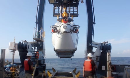 HOV Alvin being lowered into the Galápagos marine reserve. The submersible can take two scientists to depths of 6,500 metres.