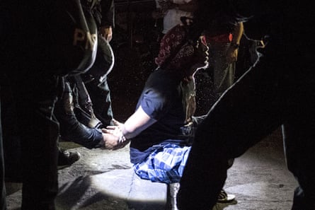 Philippine Drug Enforcement Agency agents and police arrest an alleged drug dealer during a 2018 raid in Maharlika village, Taguig, south of Manila