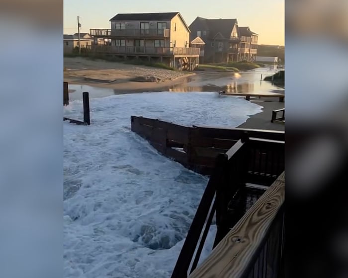 Footage shows houses battered by waves during Hurricane Erin – video