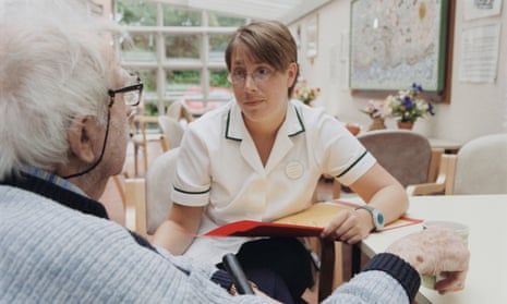 Female occupational therapist talking and listening to elderly man