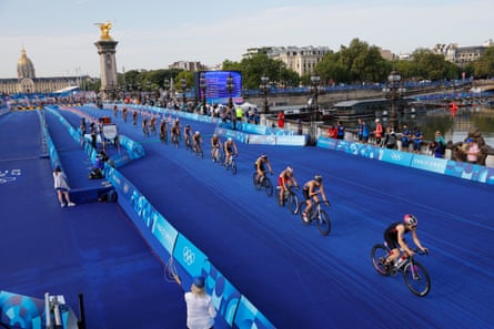 The women competitors zoom over the Seine during the cycling leg of the race