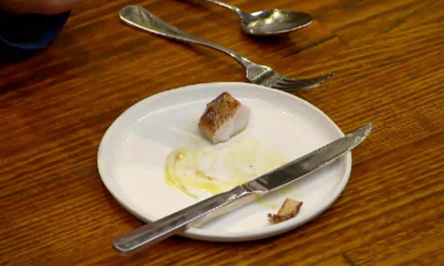 white plate with chunk of white meat and a knife on it