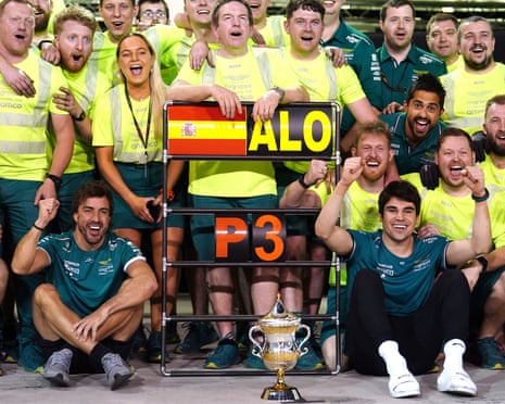 Fernando Alonso (bottom, second left) celebrates with his Aston Martin team after last year’s podium finish in Bahrain