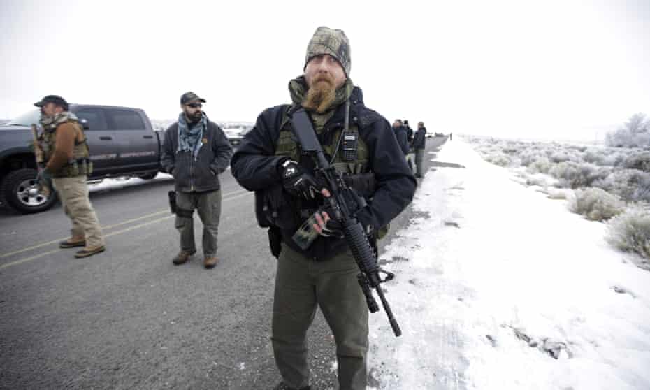 A man stands guard after members of the extremist 3% of Idaho group and several organizations arrive at the Malheur National Wildlife Refuge in 2016 during the standoff.