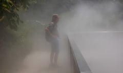 A man walks through cooling mist
