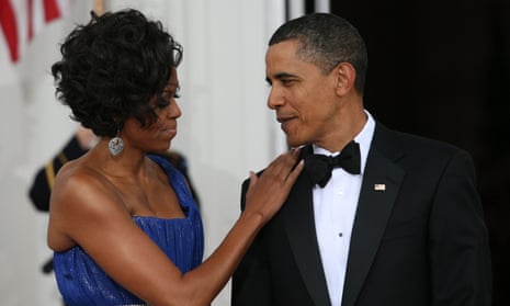 Michelle Obama places hand on Barack Obama's shoulder