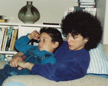 Joe Black sitting on his mother’s lap on a sofa, aged about seven