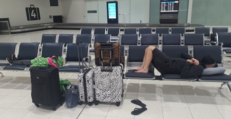 Jason Heywood (right) and his son sleeping in Perth airport on Father's Day morning.