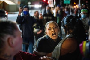 A woman standing in a crowd shouting