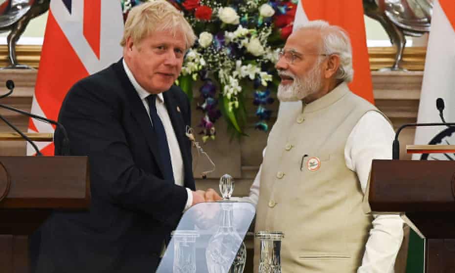 Boris Johnson (left) and India's prime minister, Narendra Modi, shake hands after a joint press briefing following their meeting in New Delhi