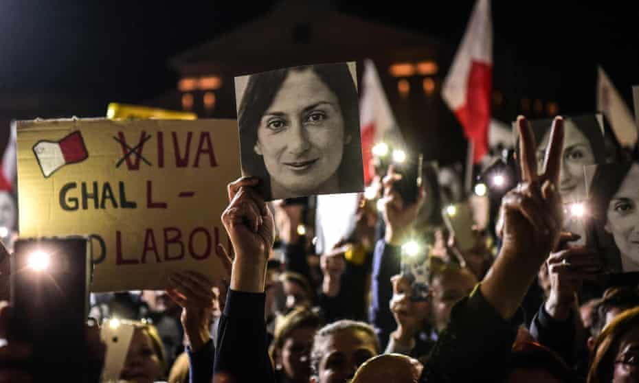 People holding placards and photographs of killed journalist Daphne Caruana Galizia outside the prime minister’s office in Valletta.