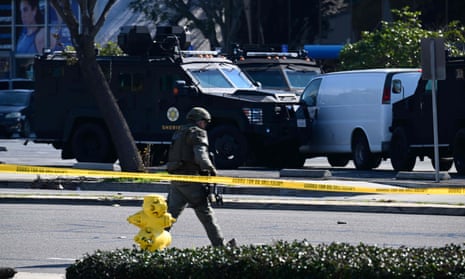 Law enforcement personnel surround a white van in Torrance, California, that could be linked to the Monterey Park suspect.