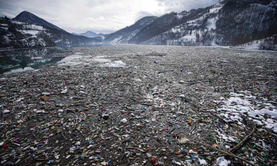 Plastic bottles and other garbage floats in the Potpecko lake near Priboj, in southwest Serbia, January 2021.