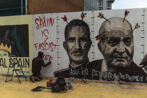 A graffiti artist works on a mural supporting Pablo Hasél