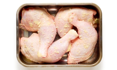 Chicken legs marinating in a baking dish