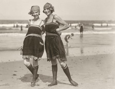 Sepia image of flapper girls on the Atlantic shore posing in the latest beachwear fashion, circa 1920