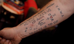 Neil Ruddock shows off the tattoos on his right arm.