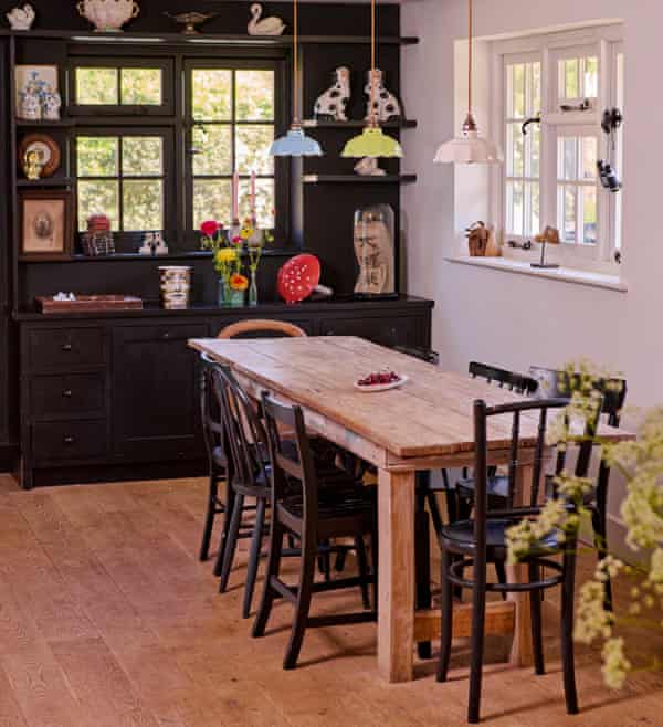 Black shelving in the kitchen of the home of fashion designers Justin Thornton and Thea Bregazzi in Walberswick, Suffolk