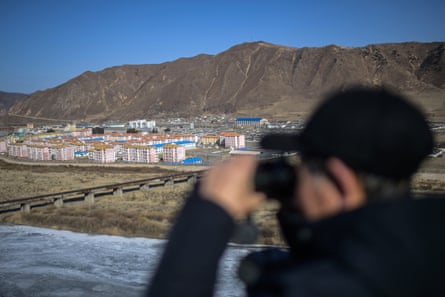 A man looks towards the North Korean city of Namyan from northeast China.