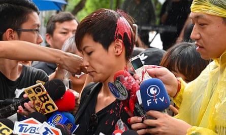 Denise Ho has red liquid thrown at her during a media appearance outside parliament in Taipei on Sunday.