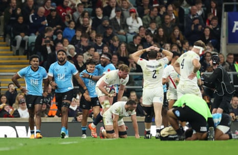 Fiji's Caleb Muntz celebrates with teammates after scoring their second try.