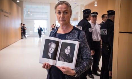 French pulmonologist Irene Frachon poses with a book of Mediator victims’ portraits during the opening day of a trial at the Paris courthouse.