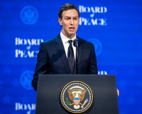man in suit speaks at lectern with US presidential seal, a blue backdrop marked 'board of peace' behind him