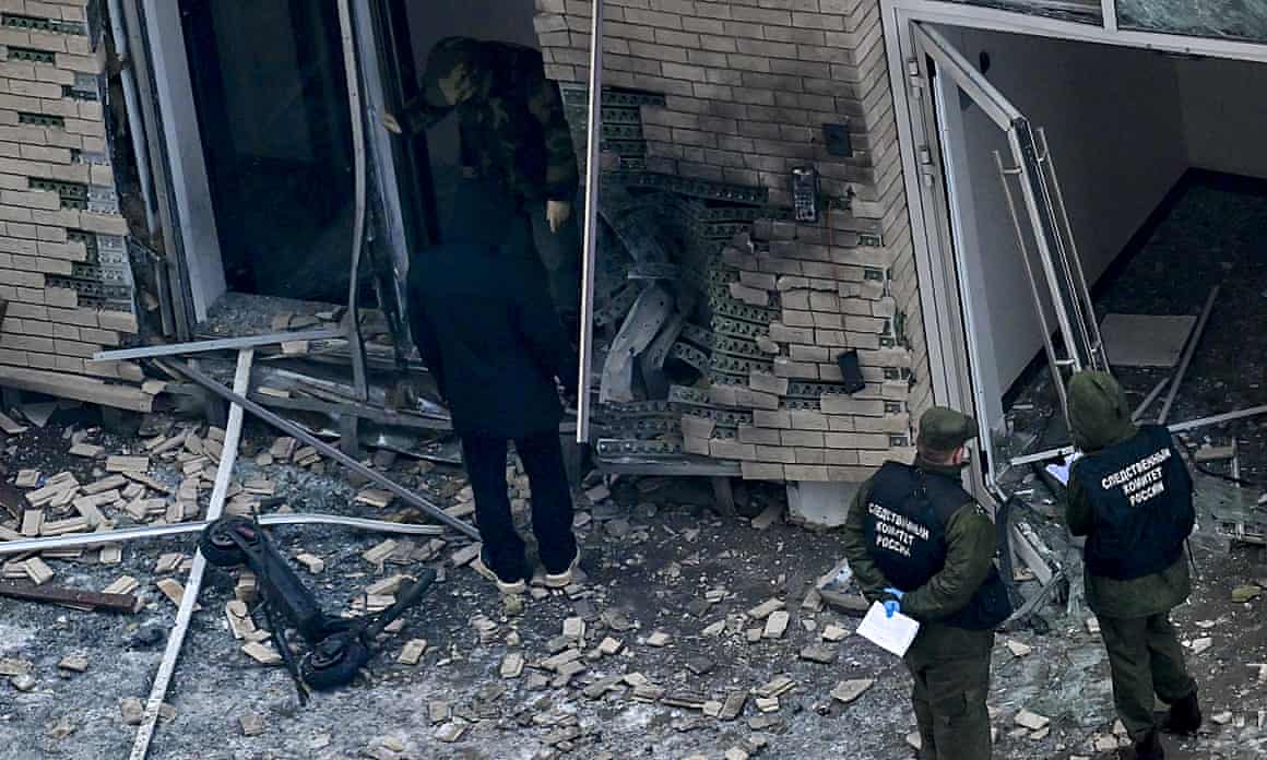 Officers outside a building damaged by an explosion