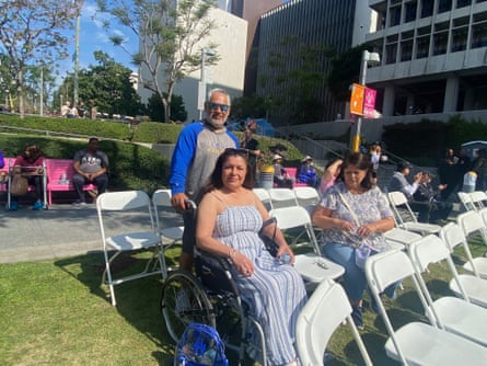 People sitting on folding chairs on the grass