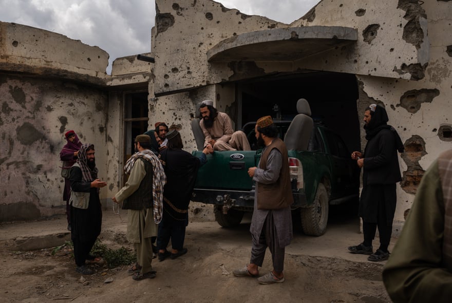 Members of the Taliban greet each other outside the district governor’s compound in Jalrez.