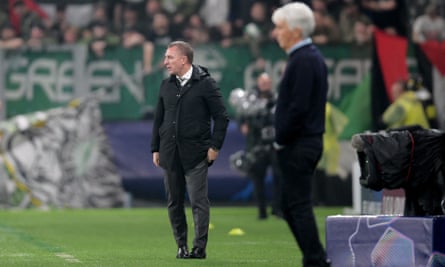 Brendan Rodgers stands on the touchline.