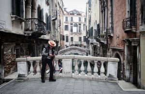 A gondolier without customers in Venice.