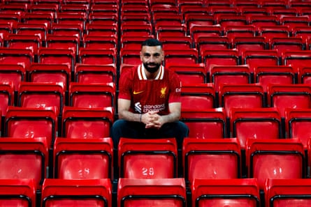 Mohamed Salah posing for photos at Anfield after signing a new contract at Liverpool