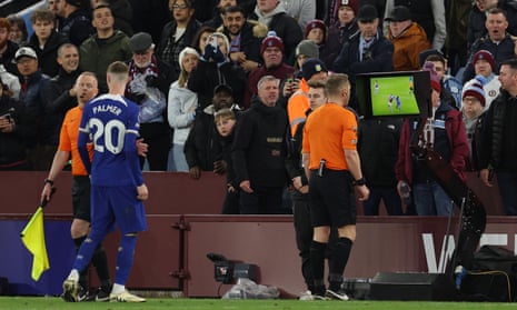 Referee Craig Pawson watches a VAR Review which concludes that a foul took place in the build up.