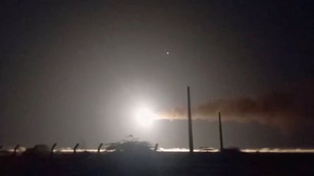 A large white light crosses the sky as the Iranian navy fires a missile