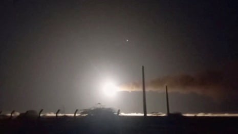 A still image from a video showing a missile travelling across a night sky.