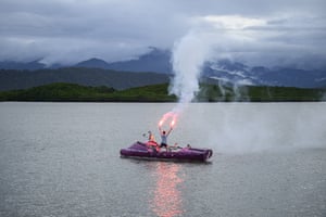 Man holding flare in boat